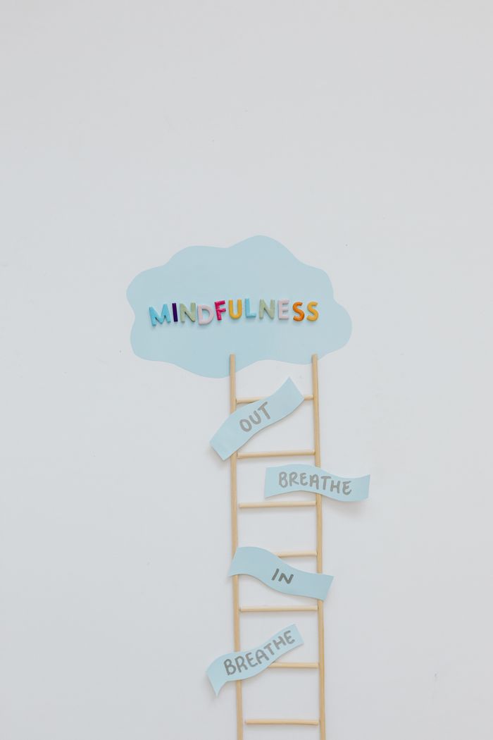 Minimalist artwork depicting mindfulness concept with a ladder and cloud on a white background.